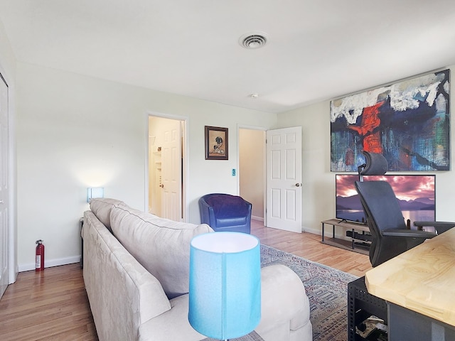 7207 Bunting Rd, Chincoteague, VA 23336 - living area featuring wood finished floors, baseboards, and an office area