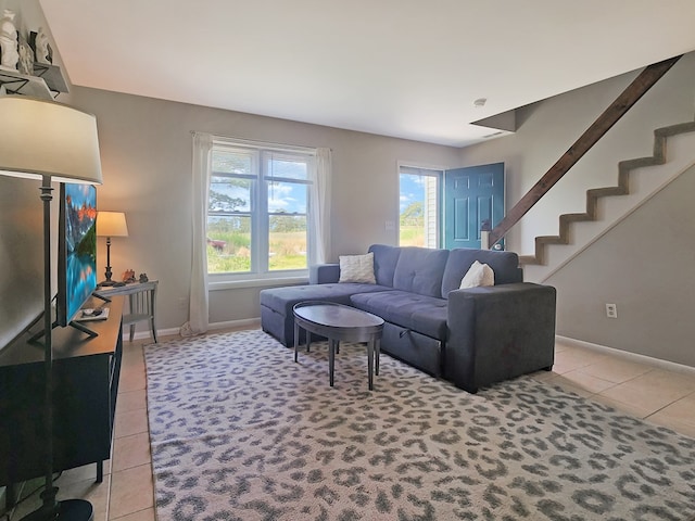 7207 Bunting Rd, Chincoteague, VA 23336 - living area with light tile patterned floors, healthy amount of natural light, and baseboards