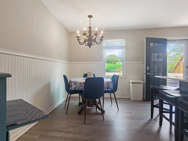 7207 Bunting Rd, Chincoteague, VA 23336 - dining room with plenty of natural light, a chandelier, wood finished floors, a wainscoted wall, and baseboards