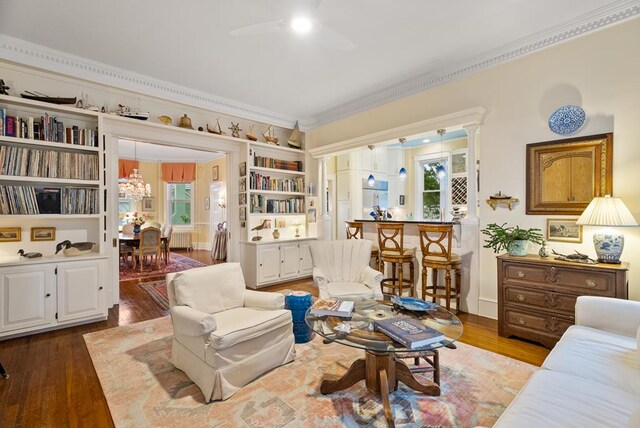 306 Bay Ave, Cape Charles, VA 23310 - living area with crown molding, ceiling fan, healthy amount of natural light, wood finished floors, and a chandelier