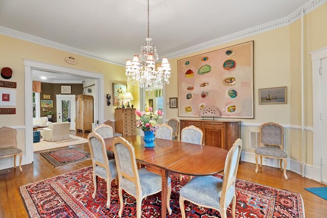 306 Bay Ave, Cape Charles, VA 23310 - dining room featuring wood finished floors, crown molding, and a chandelier