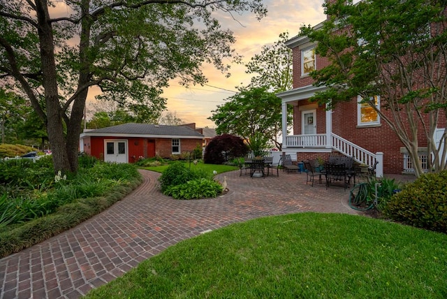 306 Bay Ave, Cape Charles, VA 23310 - yard at dusk with a lawn and a patio