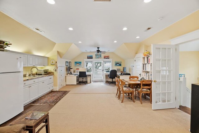 306 Bay Ave, Cape Charles, VA 23310 - dining space with a desk, light carpet, vaulted ceiling, french doors, and a ceiling fan