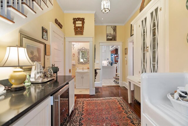 306 Bay Ave, Cape Charles, VA 23310 - entrance foyer with beverage cooler, ornamental molding, dark wood-style flooring, and baseboards