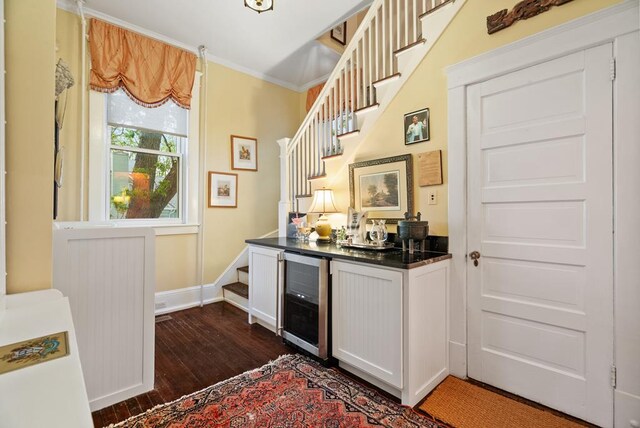 306 Bay Ave, Cape Charles, VA 23310 - indoor dry bar featuring wine cooler, stairs, dark wood-style flooring, baseboards, and ornamental molding