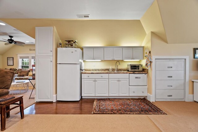 306 Bay Ave, Cape Charles, VA 23310 - kitchen featuring white appliances, a sink, ceiling fan, vaulted ceiling, and white cabinets