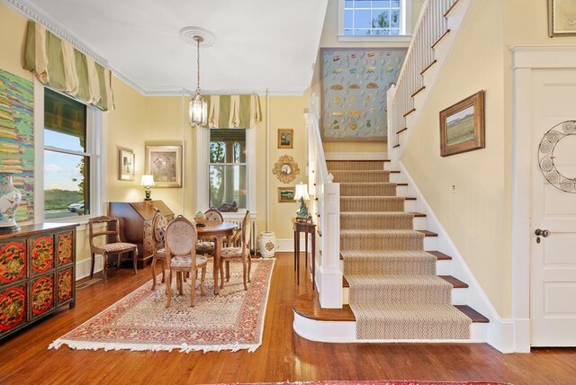 306 Bay Ave, Cape Charles, VA 23310 - dining room with stairway, healthy amount of natural light, wood finished floors, and ornamental molding