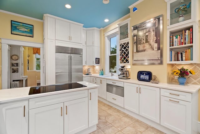 306 Bay Ave, Cape Charles, VA 23310 - kitchen featuring stainless steel built in refrigerator, black electric stovetop, a warming drawer, tasteful backsplash, and ornamental molding