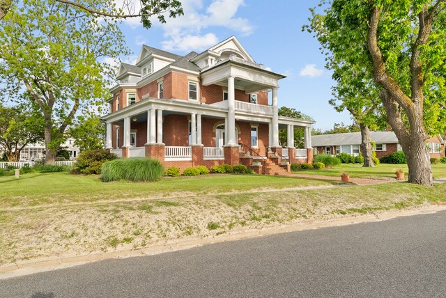 306 Bay Ave, Cape Charles, VA 23310 - neoclassical / greek revival house featuring brick siding, a porch, and a front yard