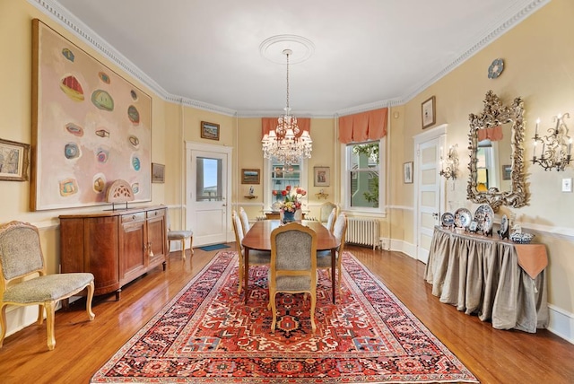 306 Bay Ave, Cape Charles, VA 23310 - dining space with a chandelier, light wood-style flooring, radiator, and ornamental molding