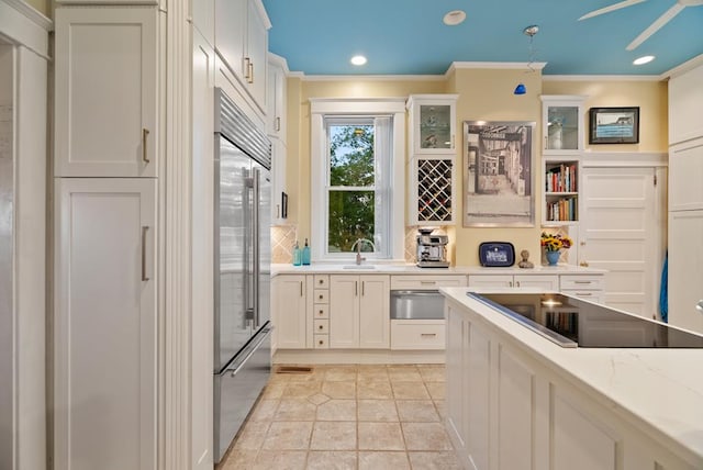 306 Bay Ave, Cape Charles, VA 23310 - kitchen featuring a warming drawer, built in refrigerator, a sink, crown molding, and black electric stovetop