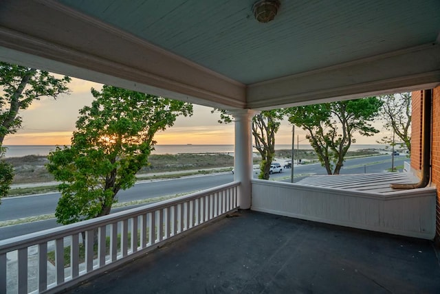 306 Bay Ave, Cape Charles, VA 23310 - balcony at dusk featuring a water view