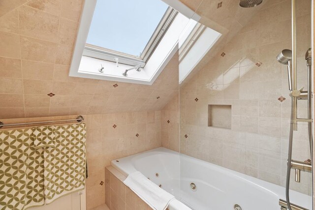 306 Bay Ave, Cape Charles, VA 23310 - full bath featuring a skylight, a whirlpool tub, tile walls, tiled shower, and lofted ceiling