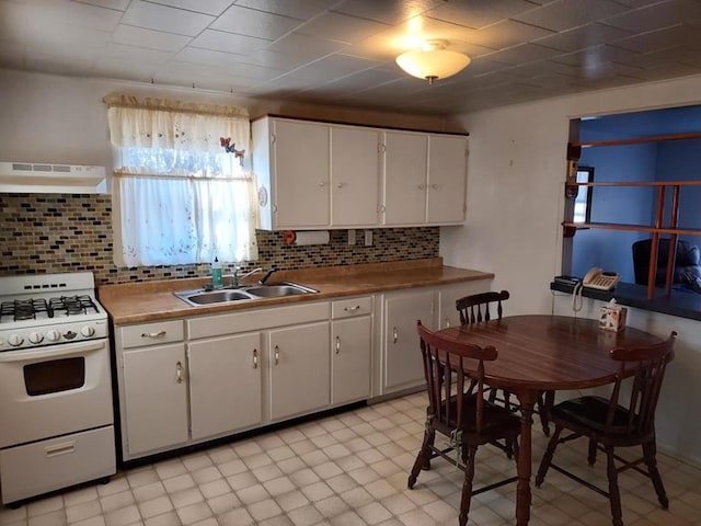 kitchen with white cabinetry, white gas stove, sink, tasteful backsplash, and exhaust hood