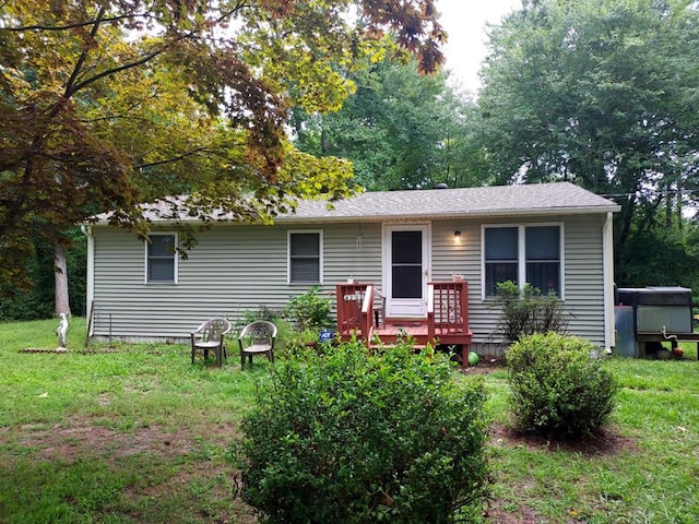 back of house featuring a yard and a wooden deck