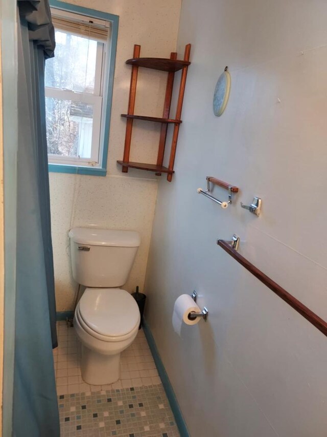 bathroom with tile patterned floors and toilet