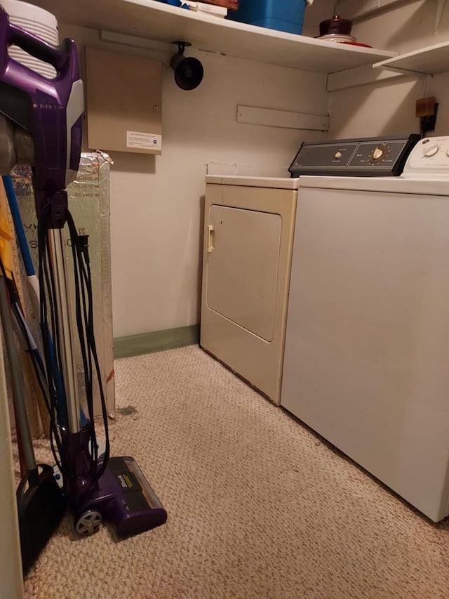 laundry room featuring separate washer and dryer and light carpet