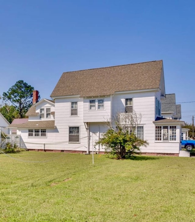 back of house featuring a yard