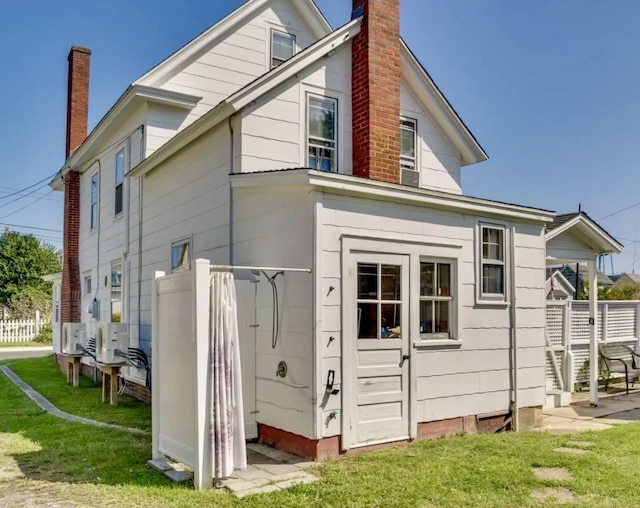 rear view of property with a lawn