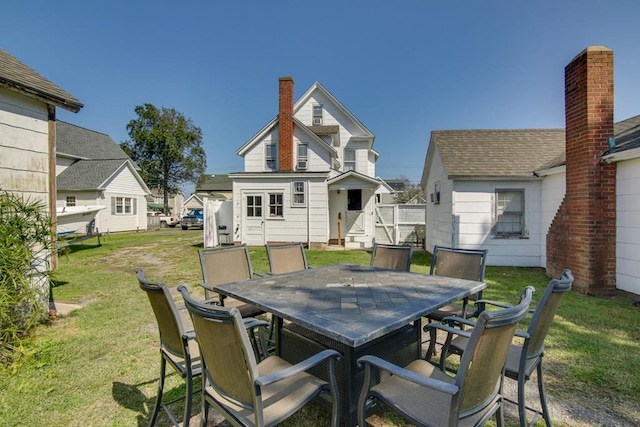 back of house featuring a lawn