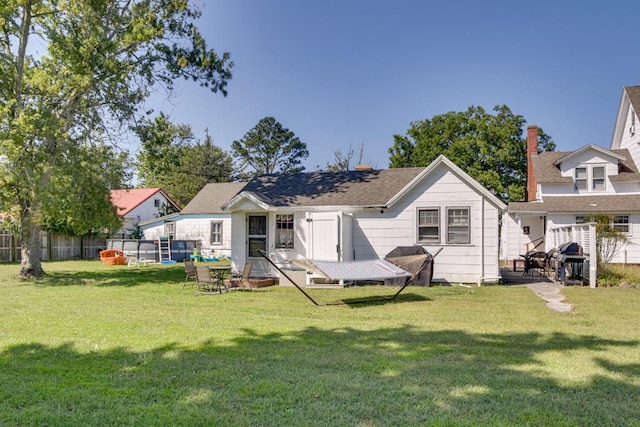 rear view of property featuring a yard