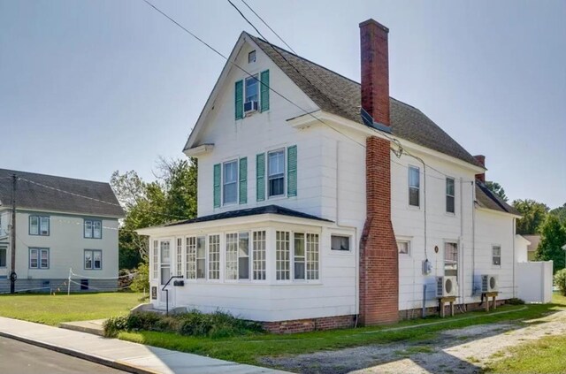 view of home's exterior with a yard