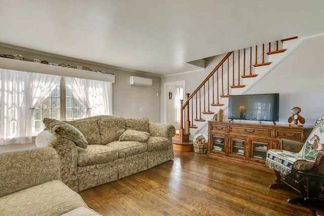 living room featuring hardwood / wood-style flooring, a wall mounted air conditioner, and crown molding