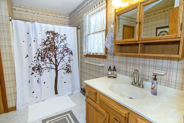 22170 Barnes Cir, Parksley, VA 23421 - bathroom with wallpapered walls, a shower with shower curtain, vanity, and marble look tile flooring