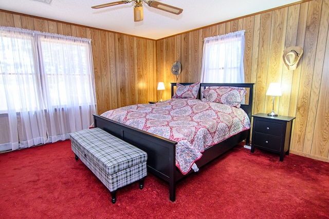22170 Barnes Cir, Parksley, VA 23421 - carpeted bedroom with wood walls and ceiling fan