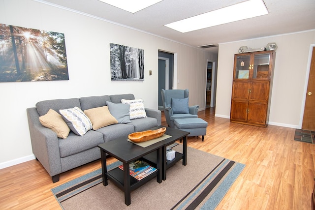 22170 Barnes Cir, Parksley, VA 23421 - living area with crown molding, light wood-type flooring, and baseboards