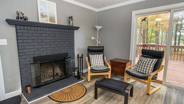 22170 Barnes Cir, Parksley, VA 23421 - living area with ornamental molding, wood finished floors, a brick fireplace, and baseboards