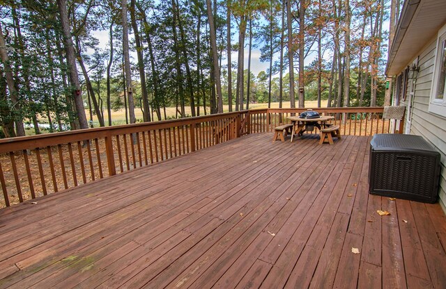 22170 Barnes Cir, Parksley, VA 23421 - wooden terrace featuring outdoor dining space and view of scattered trees