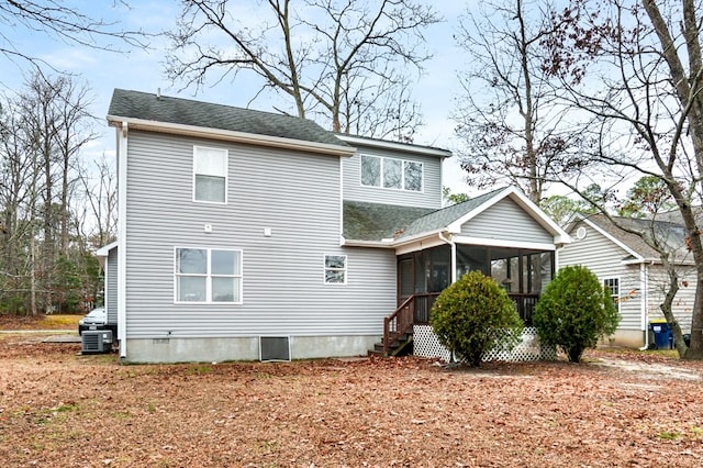 rear view of house featuring central AC and a sunroom