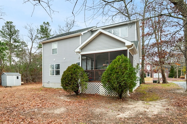 back of house featuring a shed and a sunroom