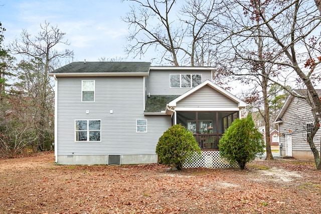 back of property with a sunroom