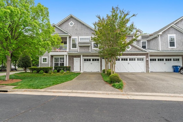 306 Troon Ct, Cape Charles, VA 23310 - townhome / multi-family property with a garage, aphalt driveway, a balcony, and a front yard