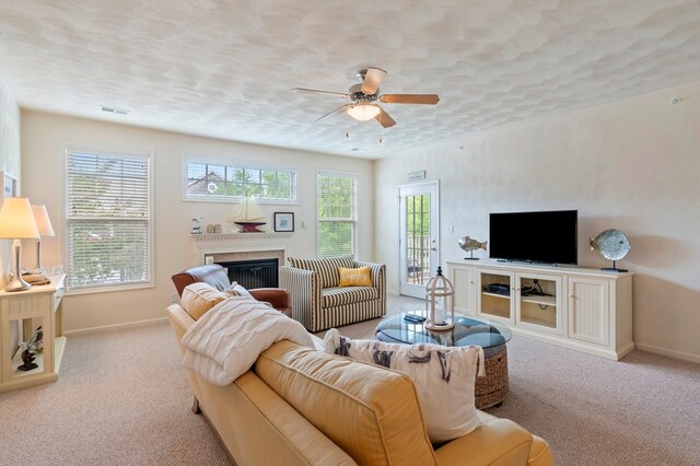 306 Troon Ct, Cape Charles, VA 23310 - living area with plenty of natural light, a ceiling fan, a glass covered fireplace, and carpet floors