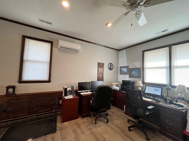 home office with ornamental molding, a wall mounted air conditioner, visible vents, and light wood-style flooring