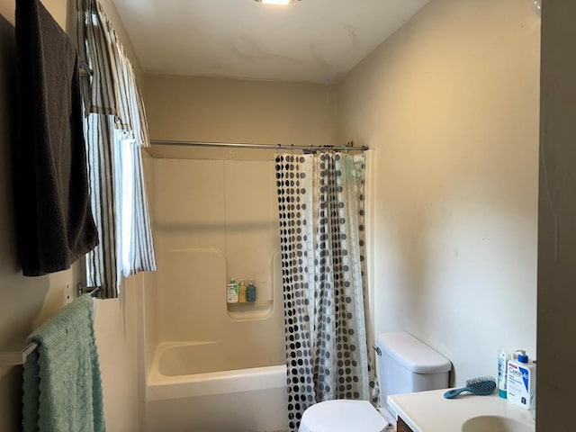 full bathroom with vanity, shower / tub combo, and toilet