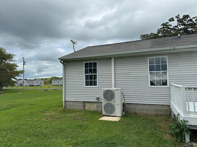 view of side of property with a lawn