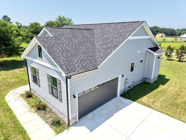 27212 Castle Row, Cape Charles, VA 23310 - view of side of home with roof with shingles, a yard, concrete driveway, and an attached garage