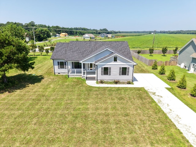 27212 Castle Row, Cape Charles, VA 23310 - view of front facade featuring covered porch, board and batten siding, concrete driveway, and roof with shingles