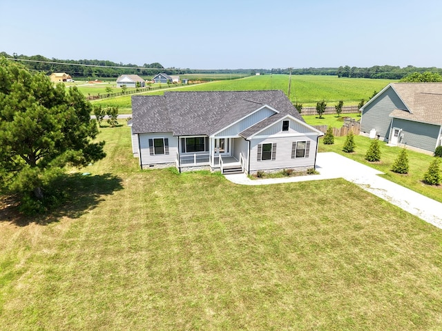 27212 Castle Row, Cape Charles, VA 23310 - view of front of home featuring a porch, concrete driveway, roof with shingles, a rural view, and board and batten siding