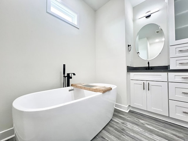 27212 Castle Row, Cape Charles, VA 23310 - bathroom with vanity, a freestanding tub, and wood finished floors