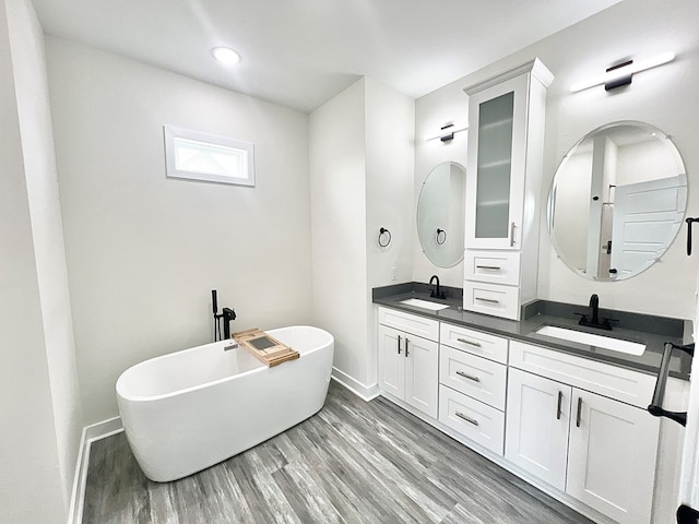 27212 Castle Row, Cape Charles, VA 23310 - full bath featuring double vanity, wood finished floors, a freestanding tub, and recessed lighting