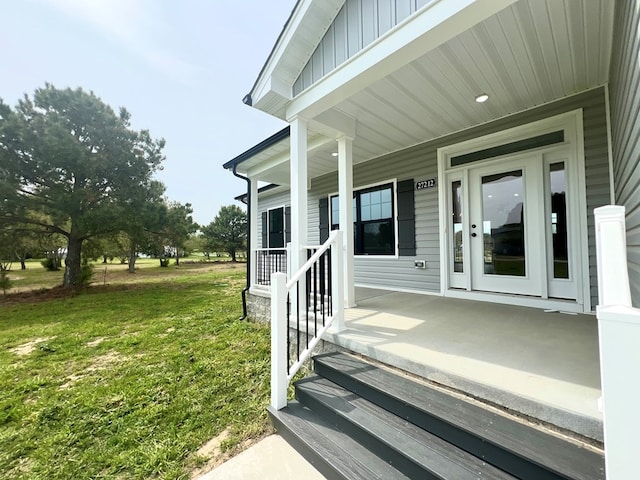 27212 Castle Row, Cape Charles, VA 23310 - entrance to property with a porch, board and batten siding, and a yard