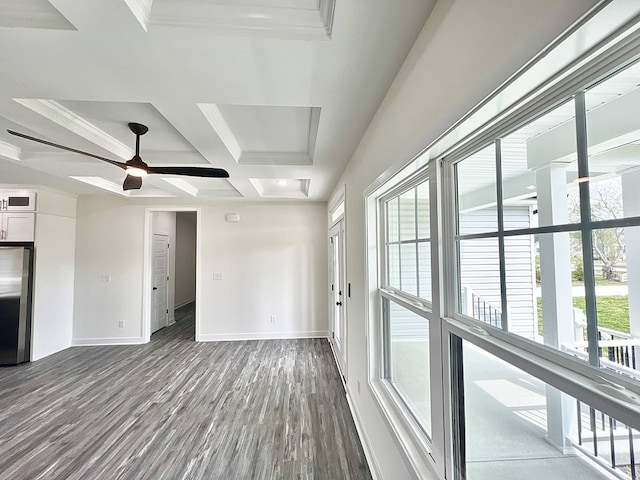 27212 Castle Row, Cape Charles, VA 23310 - unfurnished living room featuring coffered ceiling, dark wood-style flooring, beam ceiling, a ceiling fan, and crown molding