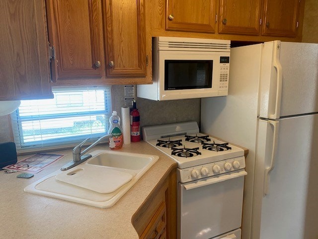 kitchen with sink and white appliances