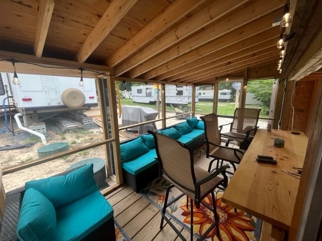 sunroom / solarium with lofted ceiling with beams