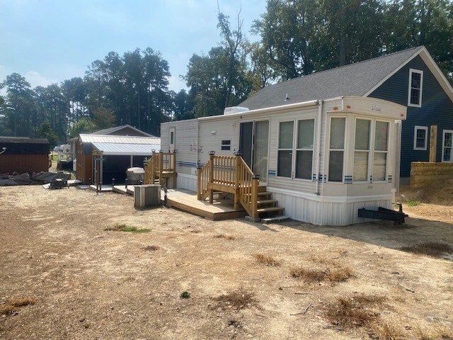 back of property with a sunroom